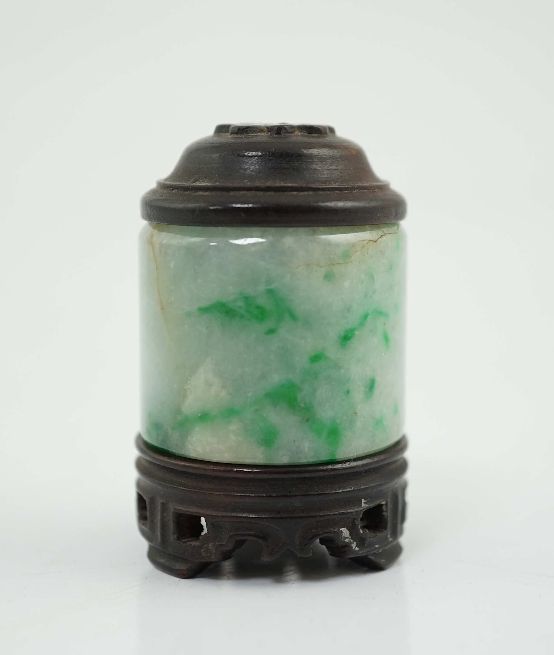 A Chinese jadeite archer's thumb ring, wood stand and cover, 19th century